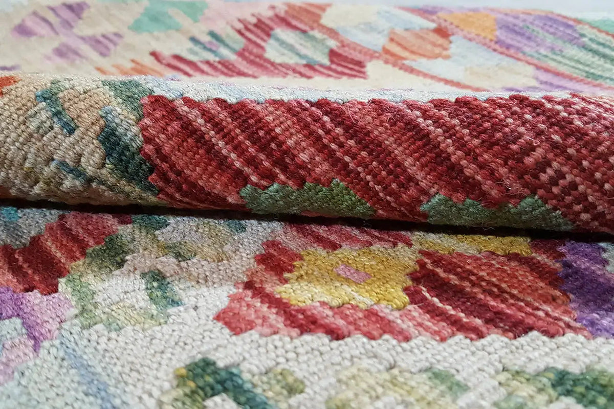 Afghan kilim detail: multicolored border and woven texture, red-green-purple