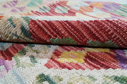 Afghan kilim detail: multicolored border and woven texture, red-green-purple
