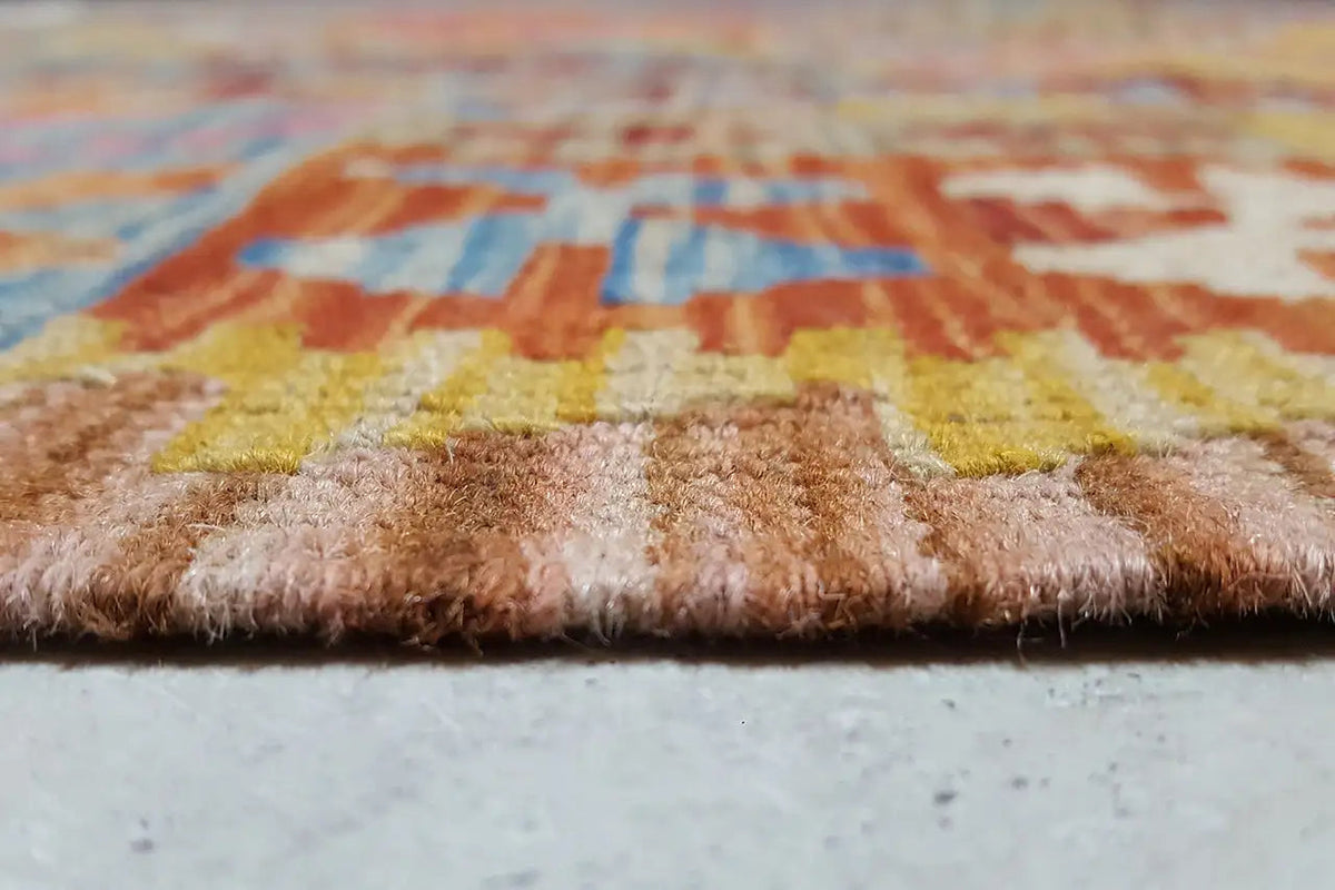 Close-up of the carpet pile: short, multicolored fibers on a woven backing