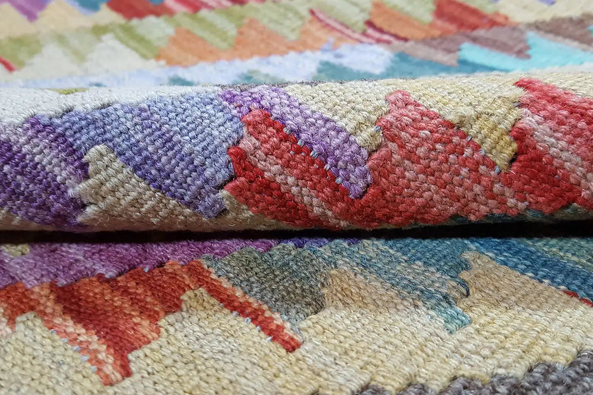 Afghan kilim: wool detail with purple and red zigzag/diamond lines