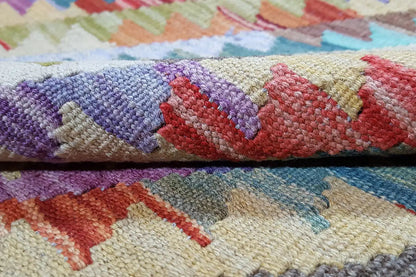 Afghan kilim: wool detail with purple and red zigzag/diamond lines