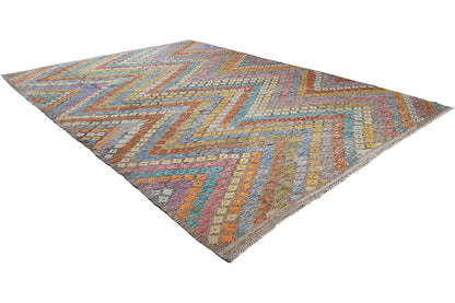 Afghan kilim with zigzag patterns, colorful blocks of color, and a hemmed edge