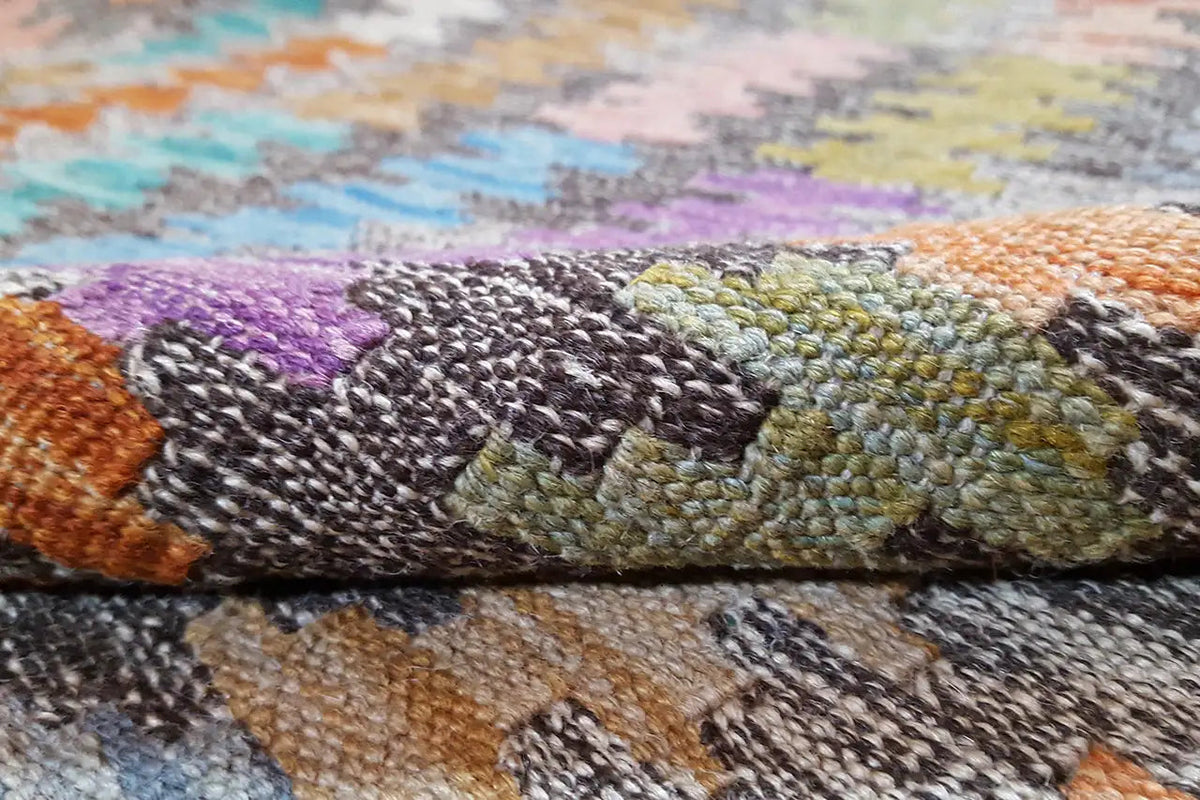 Close-up of the kilim rug: durable texture, multicolored yarns