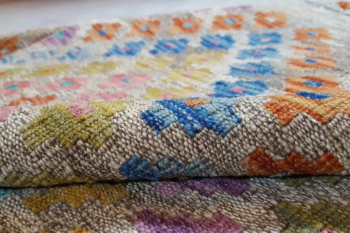 Close-up of the kilim fabric with colorful chevron color blocks and contrasting accents