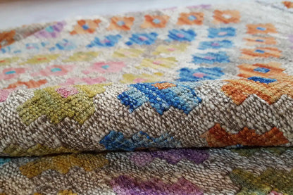 Close-up of the kilim fabric with colorful chevron color blocks and contrasting accents