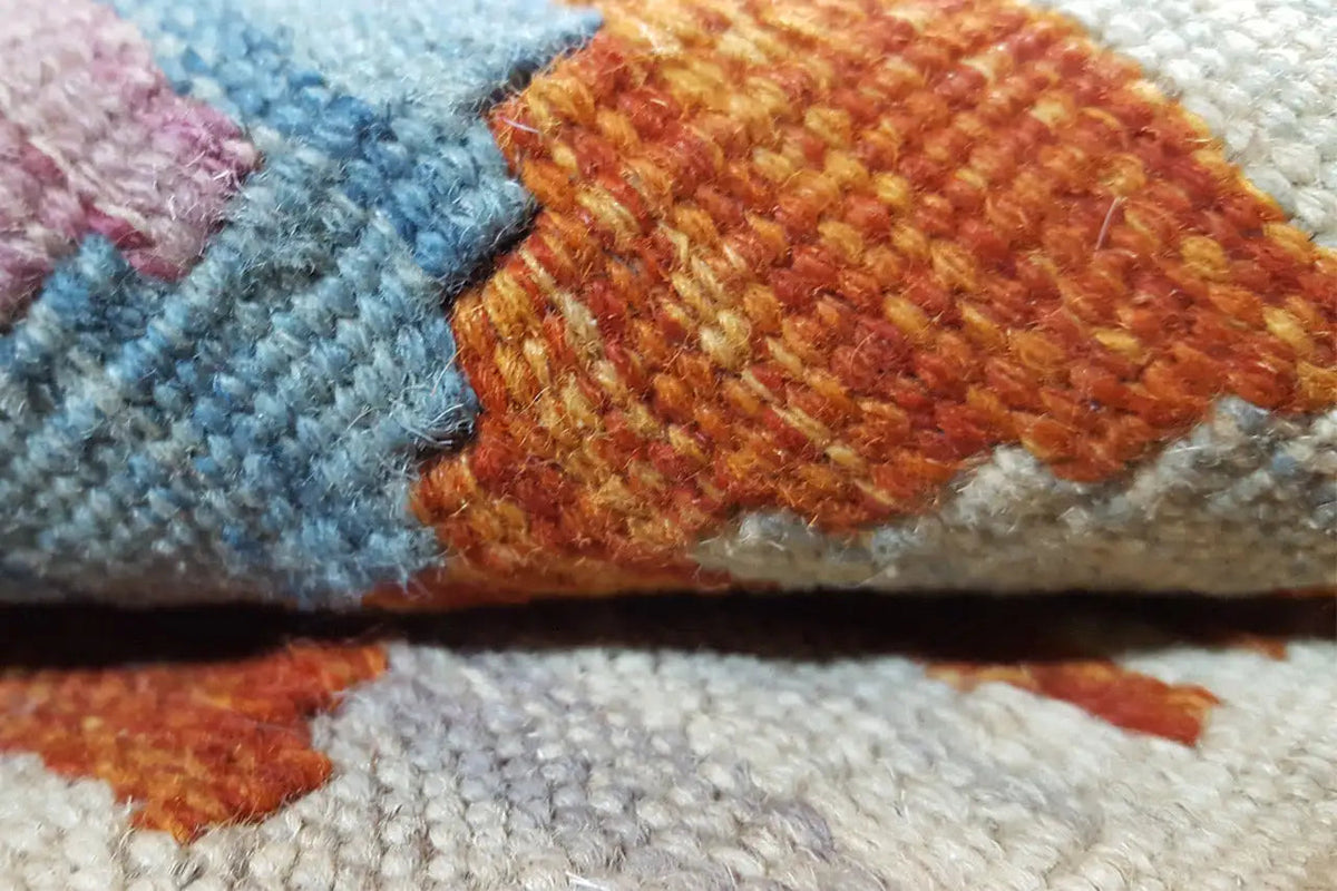Close-up: kilim weave structure with colorful threadwork and geometric decoration.