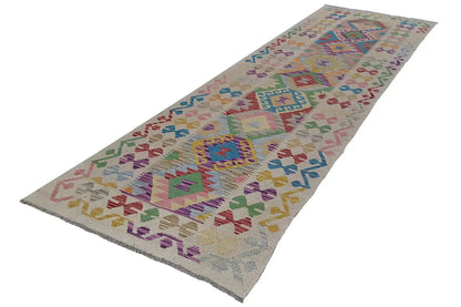 Kilim runner with a colorful pattern of diamonds and ornaments, narrow rectangular shape