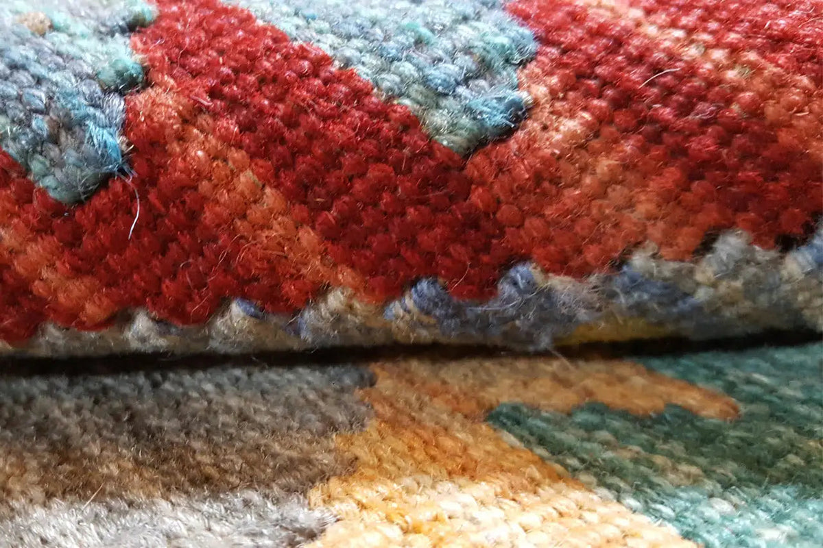 Detail of the carpet texture: red and blue-gray pile with a flatweave pattern.