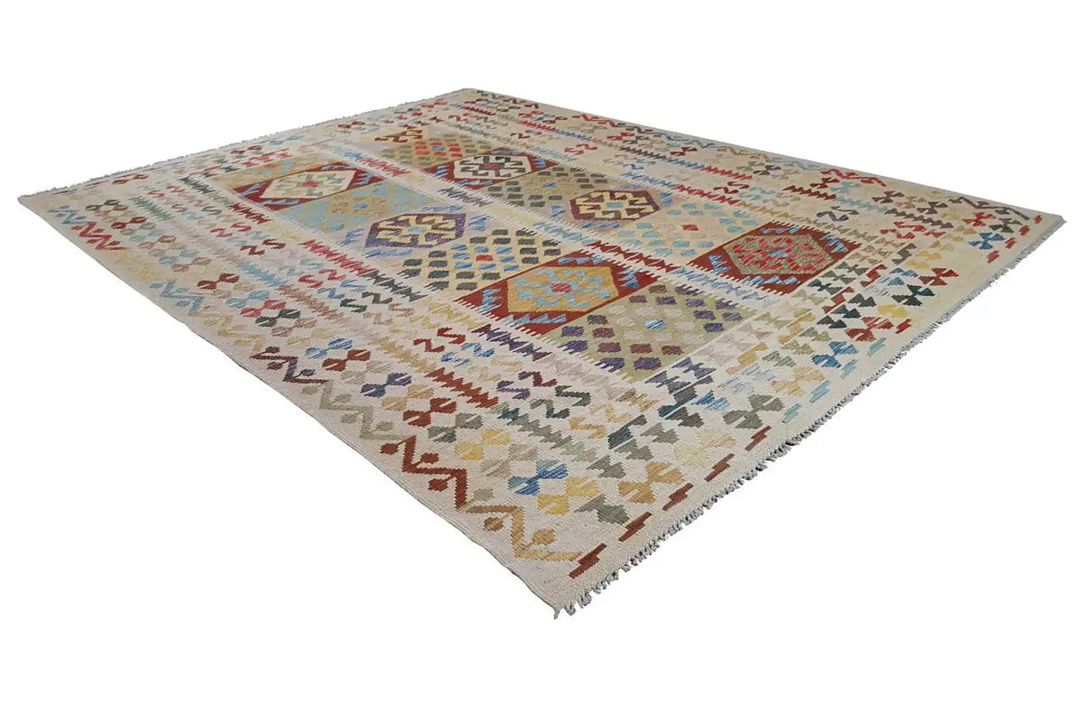 Afghan kilim rug, lying at an angle, geometric patchwork design, multicolored