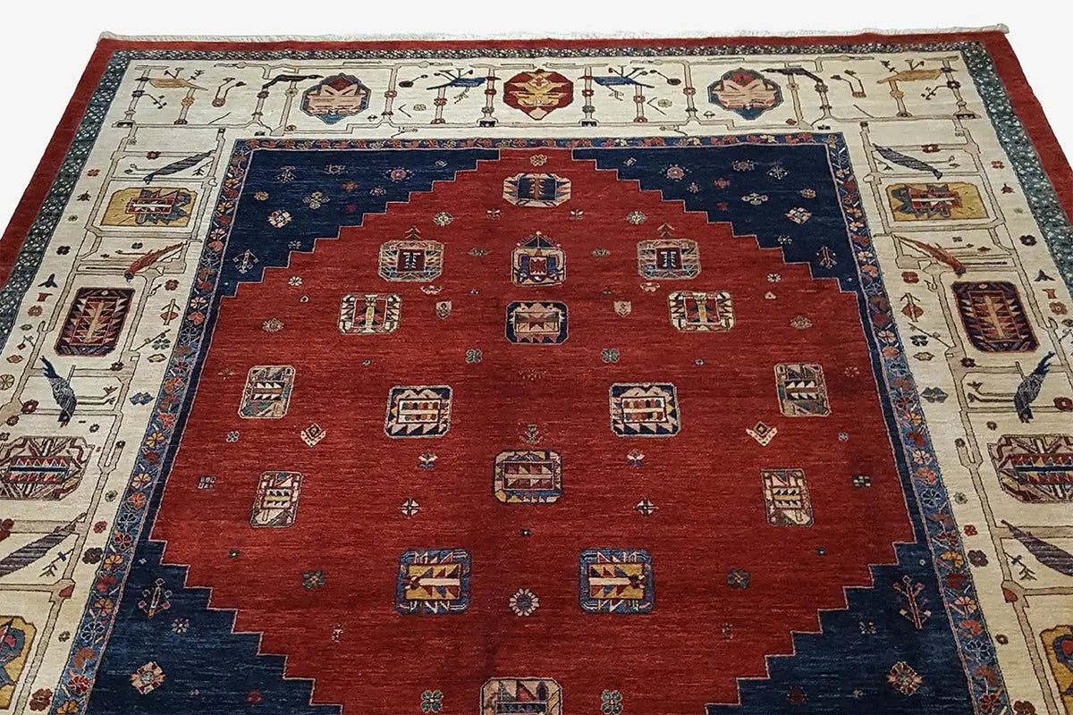 Oriental rug with a red central field, dark blue border, and cream-colored ornaments