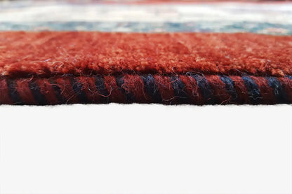 Oriental rug texture: dense pile with red and dark blue stripes along the edge