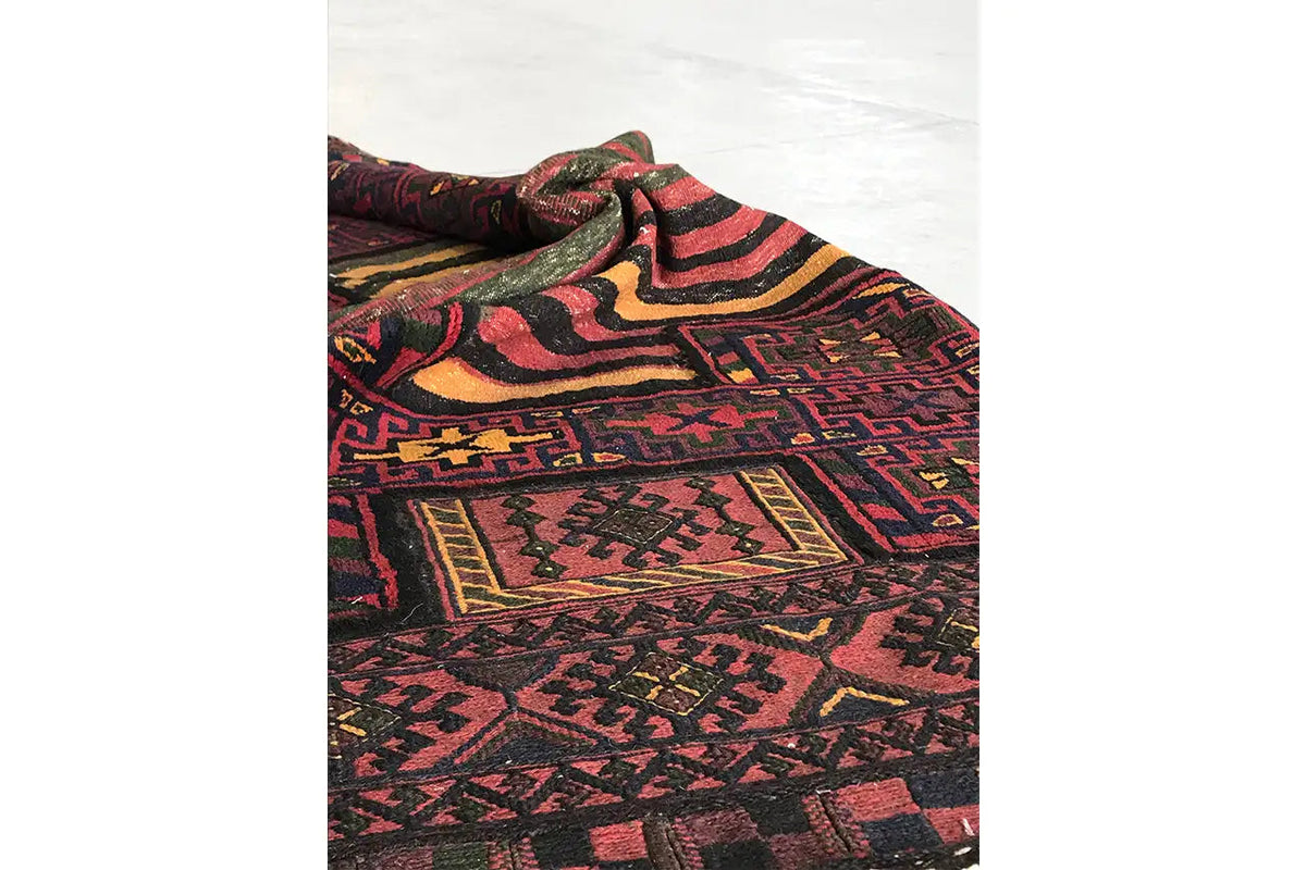 Bakhtiari kilim from the side: folded, with colorful ornaments and a visible selvedge