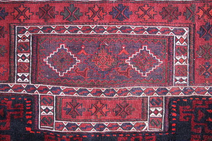 Bakhtiari kilim rug front detail: red field with several diamonds, white-blue borders.