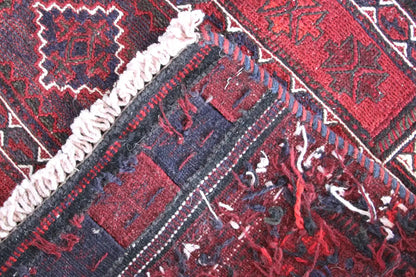 Bakhtiari kilim close-up: diagonal stripes, red and dark blue areas, fringes along the edge.