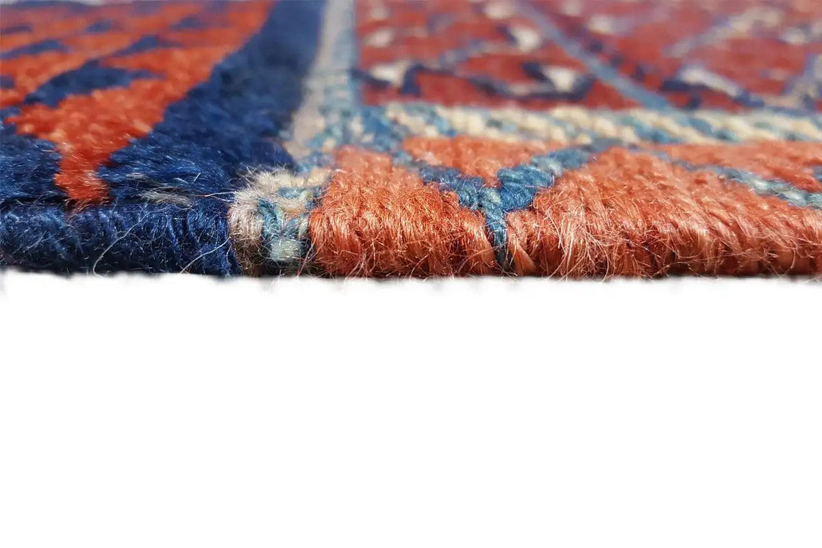 Kelim rug detail at the edge with a fringed selvedge, red, blue, cream-colored motifs
