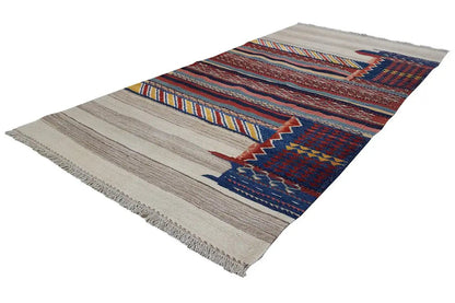 Bakhtiari rug with stripes and geometric patterns in blue, red, and beige, with fringes
