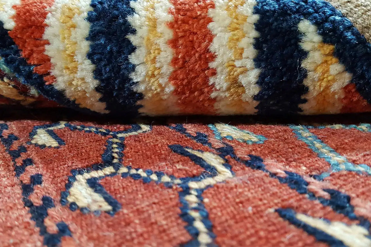 Kelim-Bakhtiari rug detail: knotted pattern with stripes and diamonds, red-blue