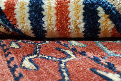 Kelim-Bakhtiari rug detail: knotted pattern with stripes and diamonds, red-blue