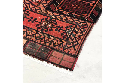 Corner of a Kelim Bakhtiari rug with fringed trim, pattern in red and dark brown