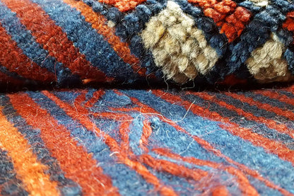 Close-up of the kilim weave: vivid blue and red tones with orange accents