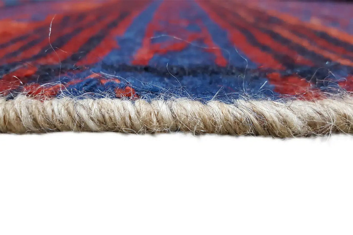 Kilim rug edge with fringes; beige background with red and blue patterns