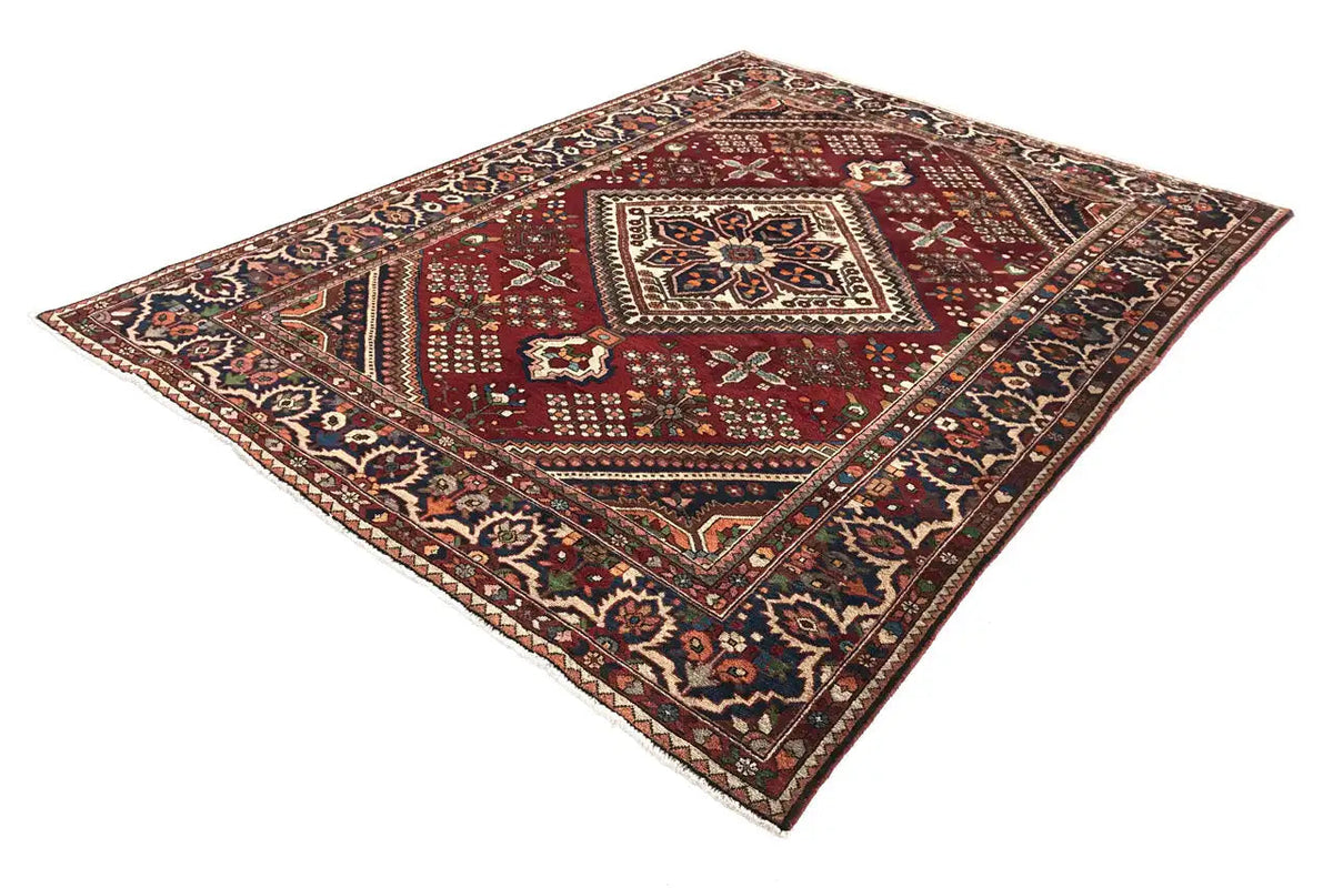 Oriental rug with a red field, central diamond medallion, and multicolored ornamental border