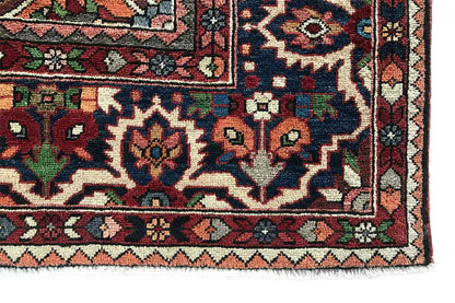 Close-up of a carpet edge with diamonds, floral ornaments, and colorful corner motifs