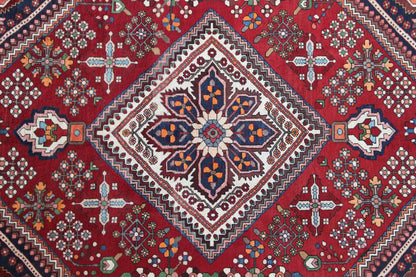 Central medallion carpet with a star-shaped design in a lozenge, on a red ground with surrounding ornaments