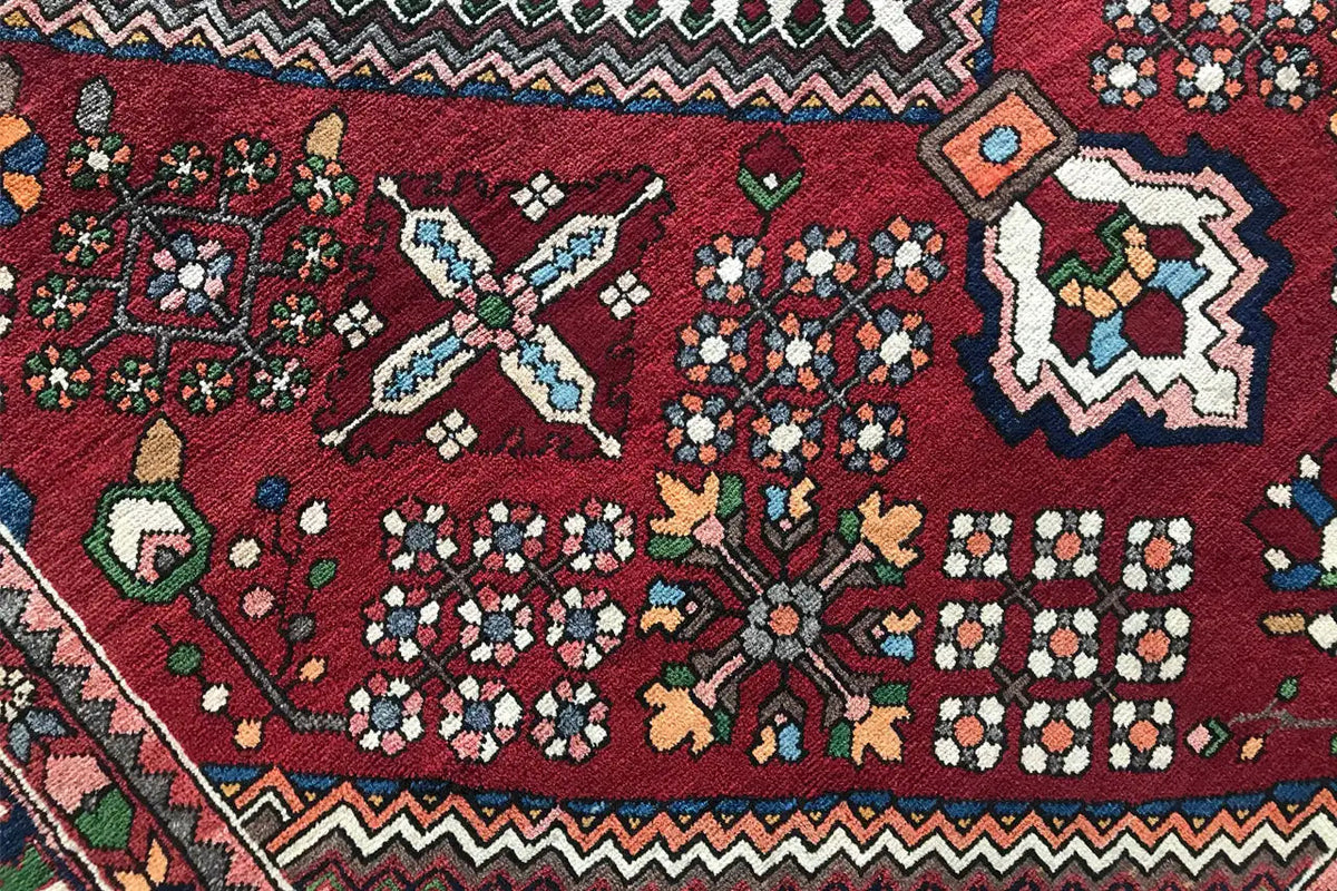 Rug: dark red diamond pattern with floral motifs and geometric border