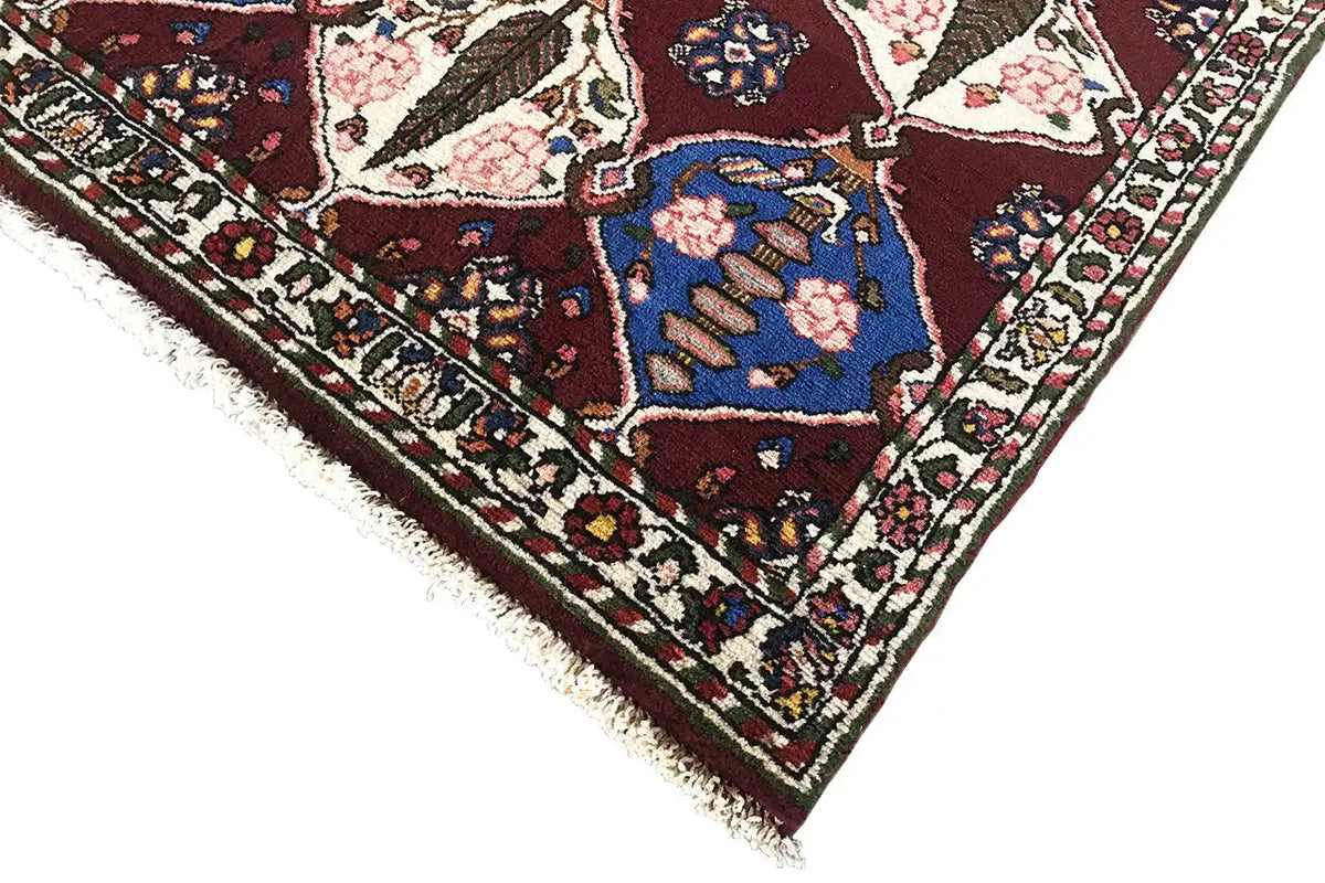 Persian Bakhtiari rug with border, burgundy background and blue motifs, fringes.