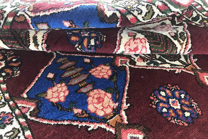 Close-up of a Bakhtiari rug: blue-red pattern with vines, floral medallions, and border decoration.