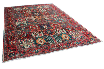 Angled oriental rug with a red border and colorful patterned fields, 315×220 cm