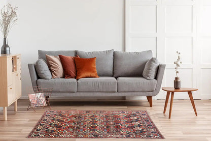 Bakhtiari rug (312x210 cm) spread across the floor, geometric pattern in red and blue