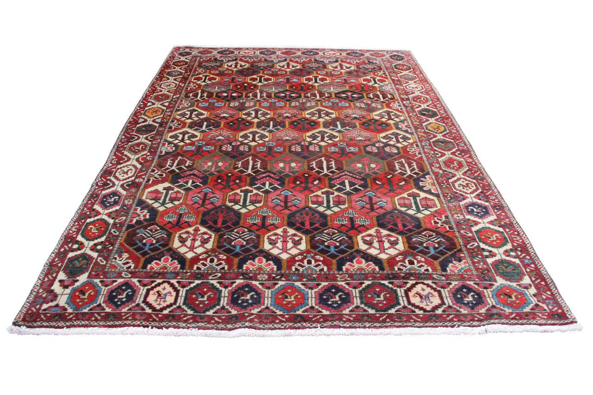 Bakhtiari rug (312x210 cm) laid flat, geometric pattern in red, blue, and beige