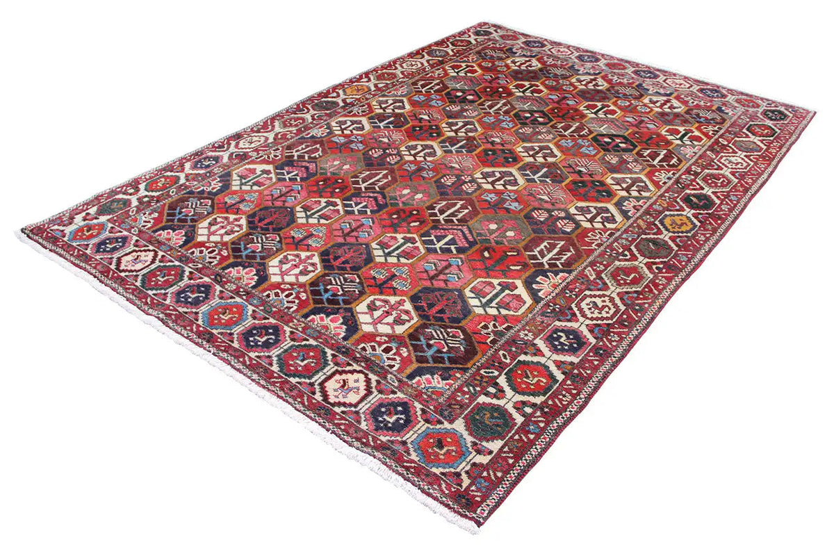 Bakhtiari rug (312x210 cm) spread out at an angle, vivid red tones and colorful ornaments