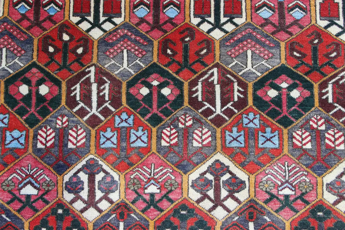 Bakhtiari rug (312x210 cm) close-up: geometric rows in red, blue, and cream
