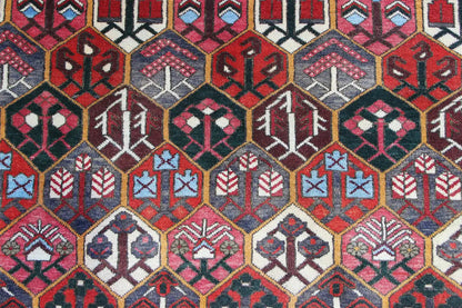 Bakhtiari rug (312x210 cm) close-up: geometric rows in red, blue, and cream