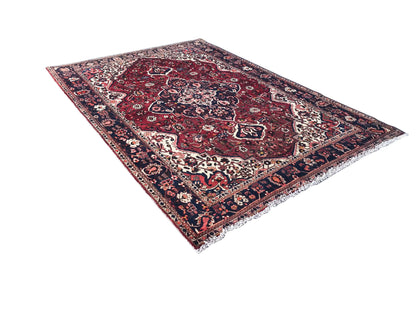 Bakhtiari rug (306x207 cm): red medallion, blue patterned border, diagonal view