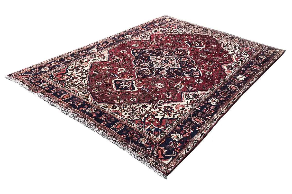 Bakhtiari rug (306x207 cm) with a floral central motif, red background, and blue border