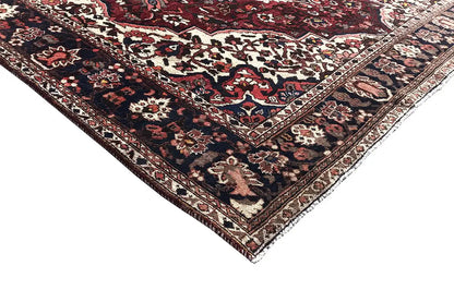 Bakhtiari rug (306x207 cm) corner: ornamental border, red background, cream-colored details