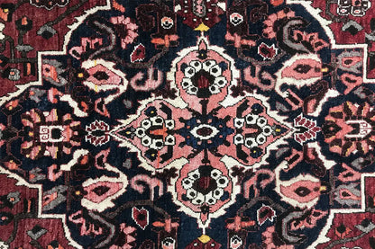 Bakhtiari rug (306x207 cm) Detail: red, blue, and cream ornamental pattern