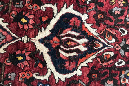 Bakhtiari rug (306x207 cm) detailed close-up with a red color field and white accents