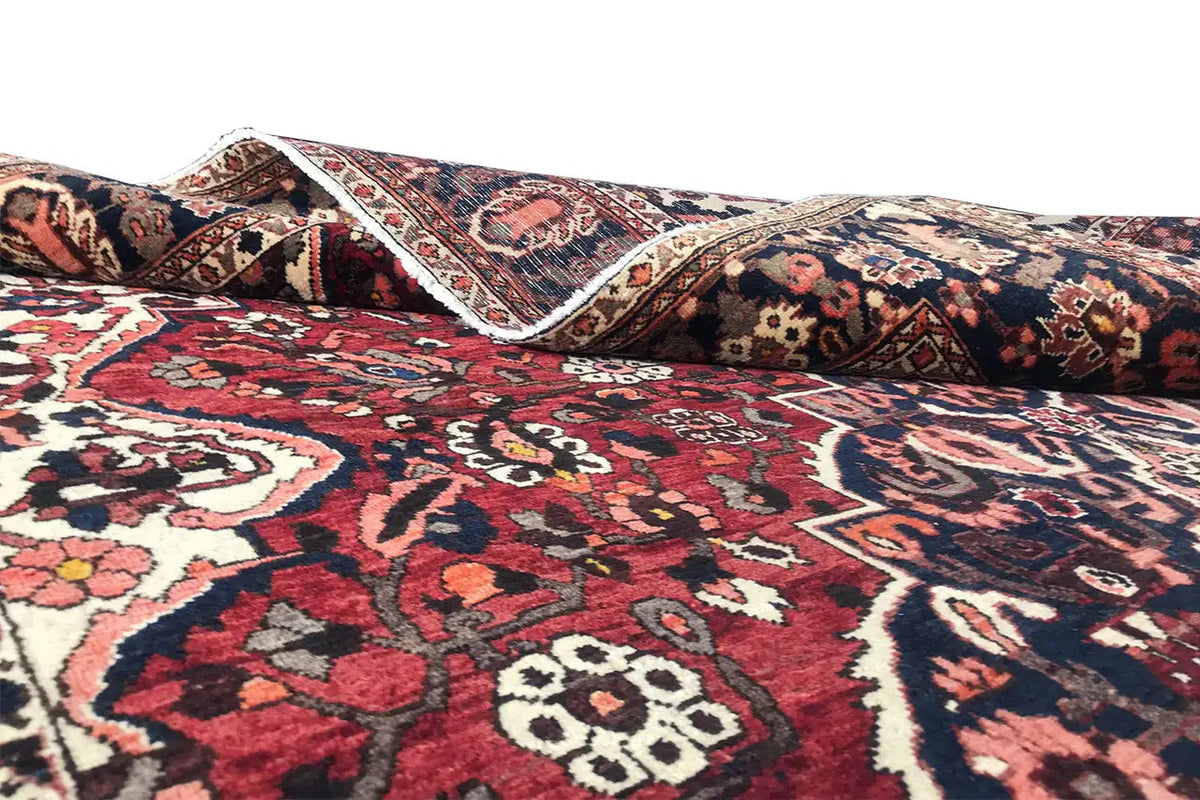 Bakhtiari rug (306x207 cm) with a red, blue and cream pattern, side angle view