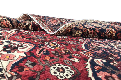 Bakhtiari rug (306x207 cm) with a red, blue and cream pattern, side angle view