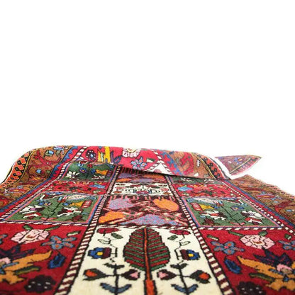 Bakhtiari rug laid out with decorative border and patterned medallions