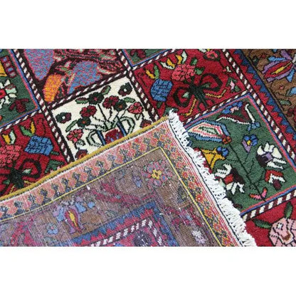 Bakhtiari carpet detail with edge fringe and a colorful medallion in the field