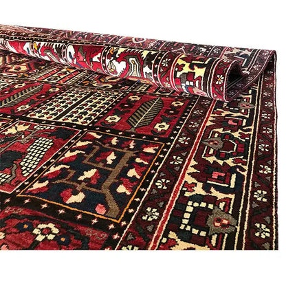 Bakhtiari oriental rug side view: hemmed border and ornamental fields in Bordeaux