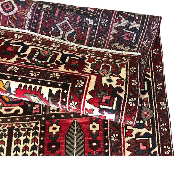 Persian rug Bakhtiari close-up of the edge: patterned sections with red, beige, and blue accents