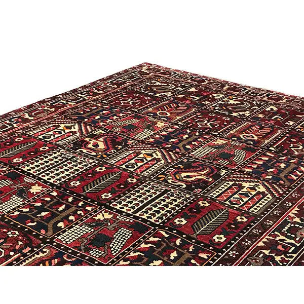 Bakhtiari Oriental rug from an angled view: central field with ornaments in burgundy
