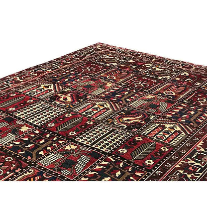 Bakhtiari Oriental rug from an angled view: central field with ornaments in burgundy